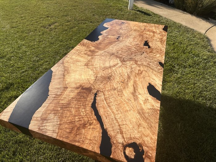 Full view of the figured maple burl tabletop with black resin