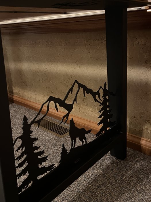 Wildlife and mountain details in the custom metal base