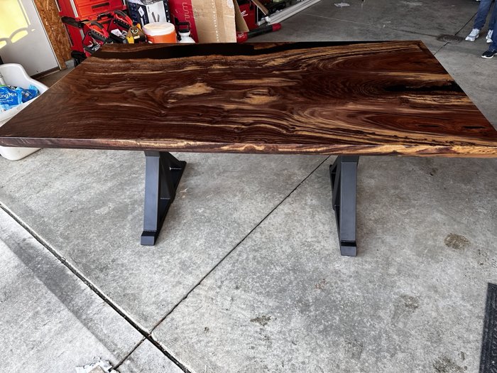 Full view of the walnut top and dark base
