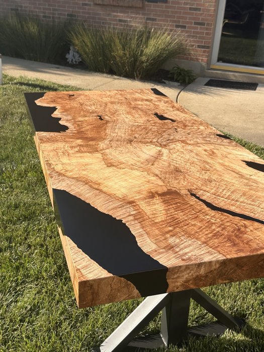 Angled view of the maple burl tabletop and its edge