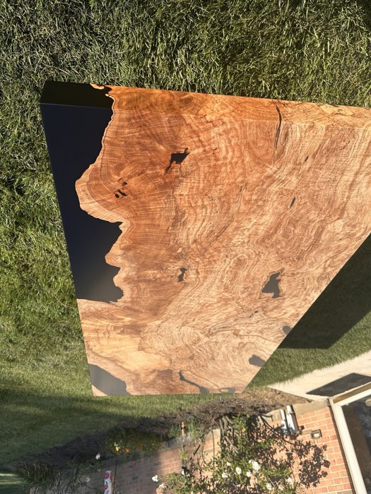 Detail of natural maple burl meeting black resin